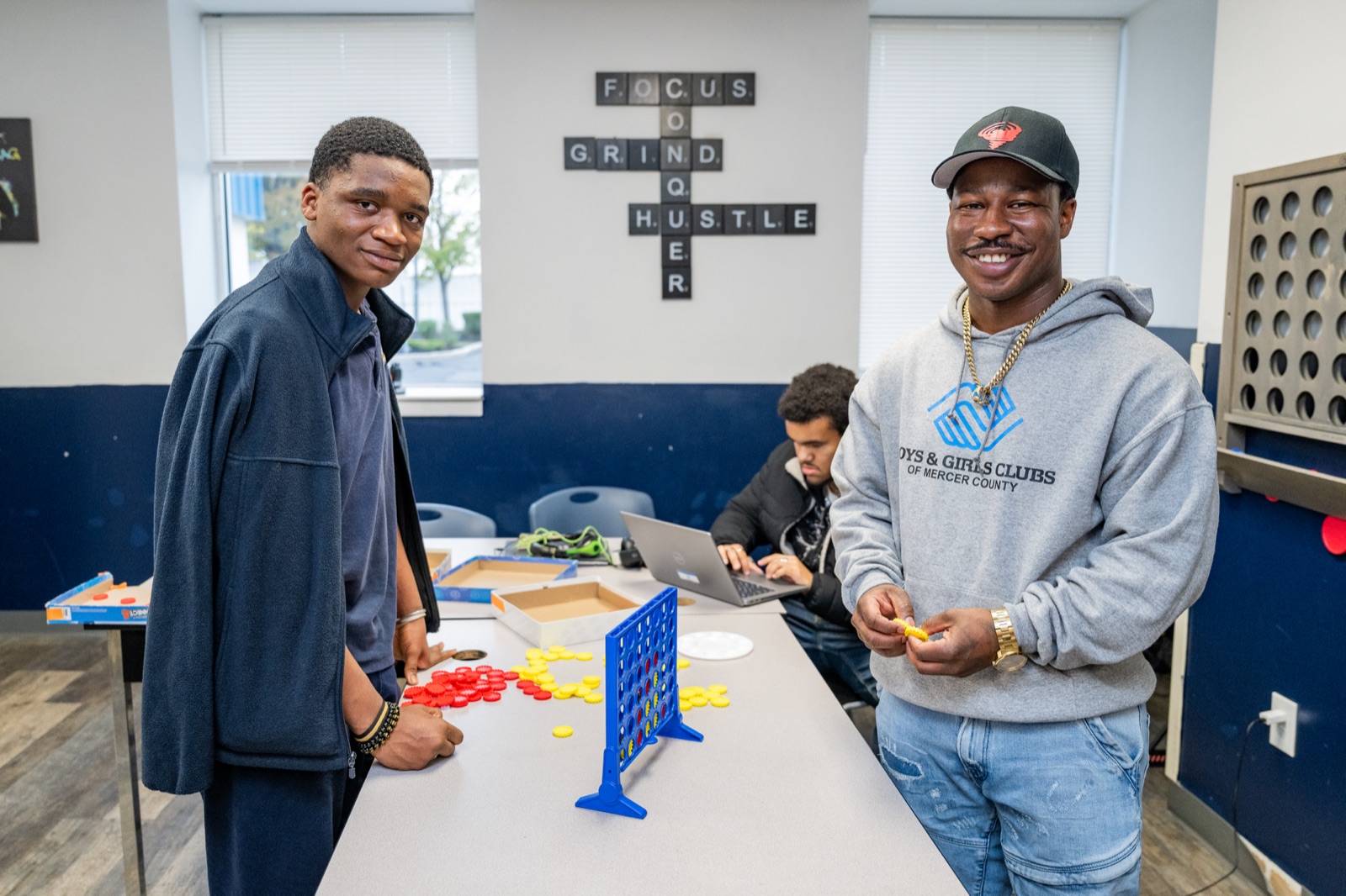 CJ Burnett mentoring a young person at a community center.